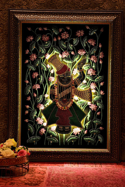 Decorative wall art with a character surrounded by flowers in a gold frame.