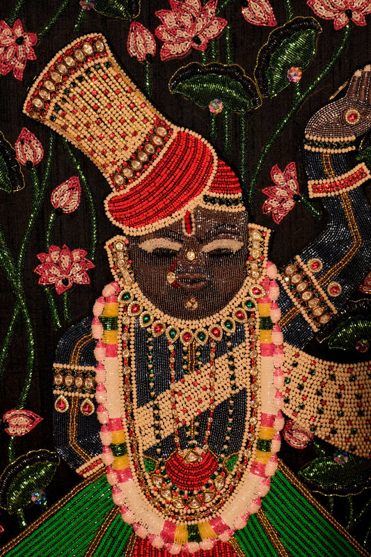 Handcrafted Shrinathji Pichwai frame with bead embroidery and green-red attire, premium home decor by Iragai.