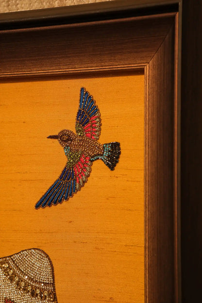 Embroidered bird design on a wooden surface
